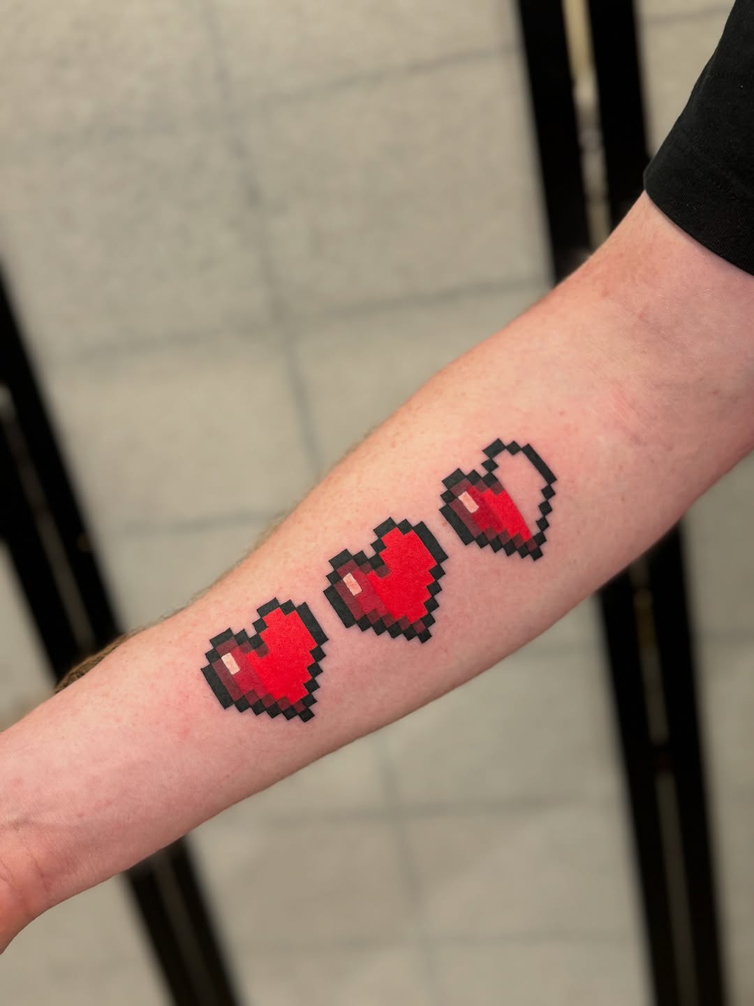 Three pixelated hearts with chunky black outlines