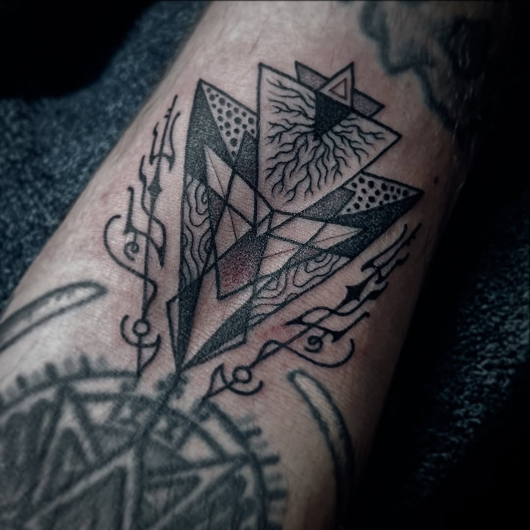 Tessellated geometric shards with dotted accents and rootlike linework.