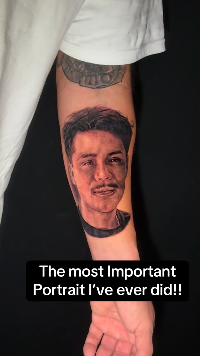 Hyper-realistic black-and-gray portrait on the forearm, exceptionally lifelike.