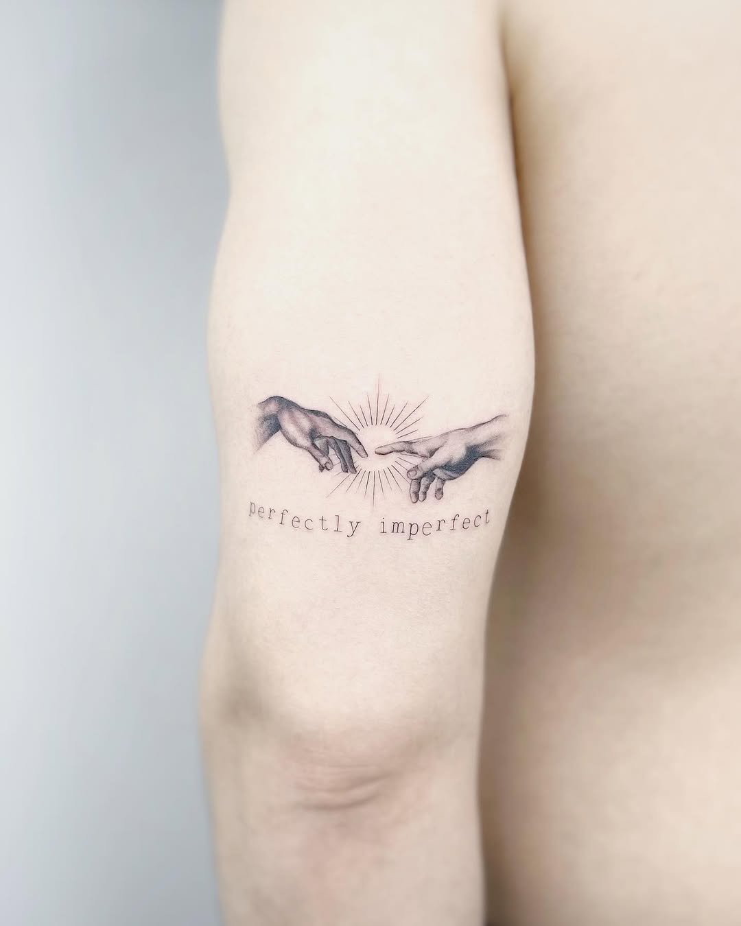 Delicate micro hands meet, Genesis-inspired, imperfectly perfect.