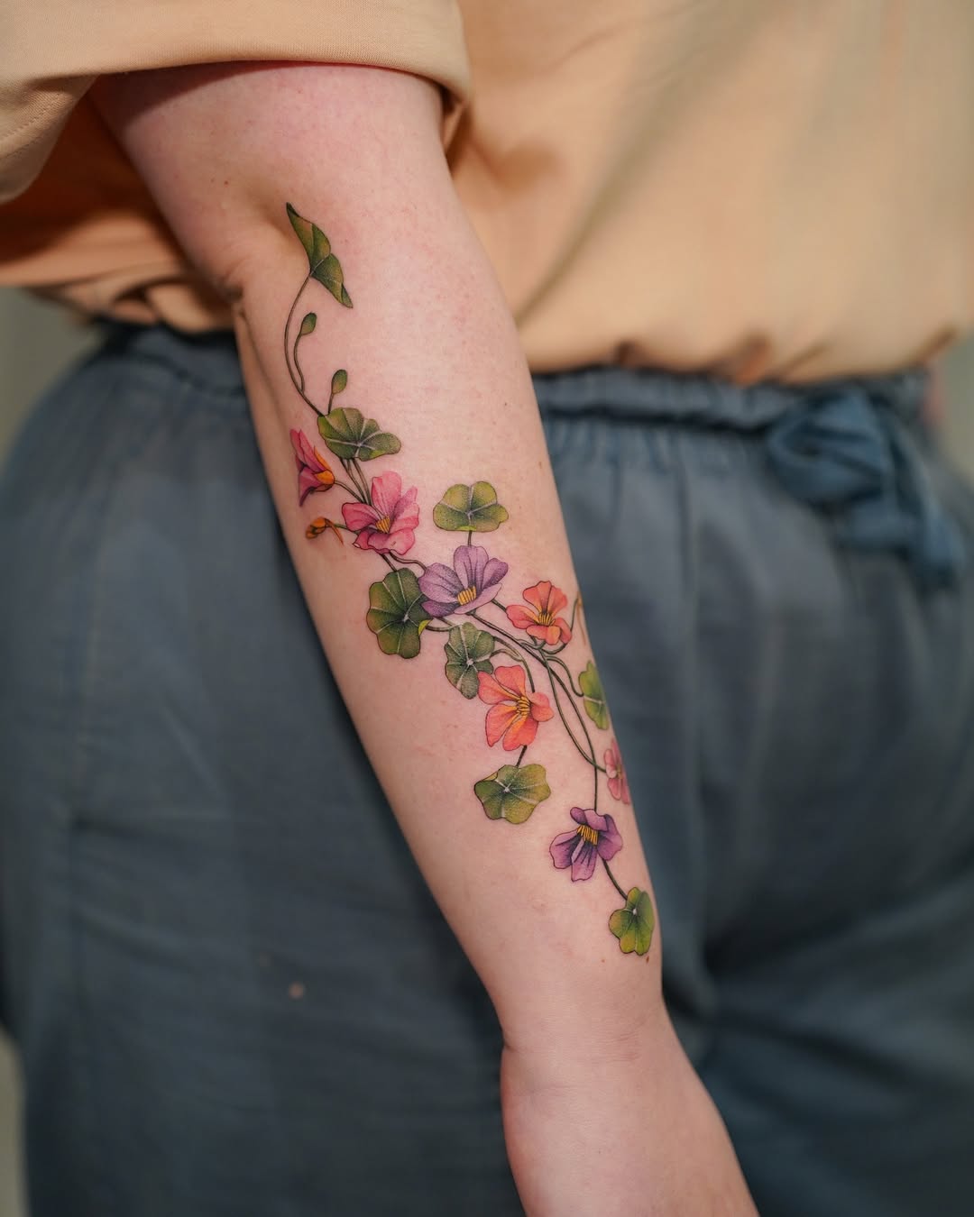 Delicate nasturtium vine with pastel blossoms, fine-line watercolor