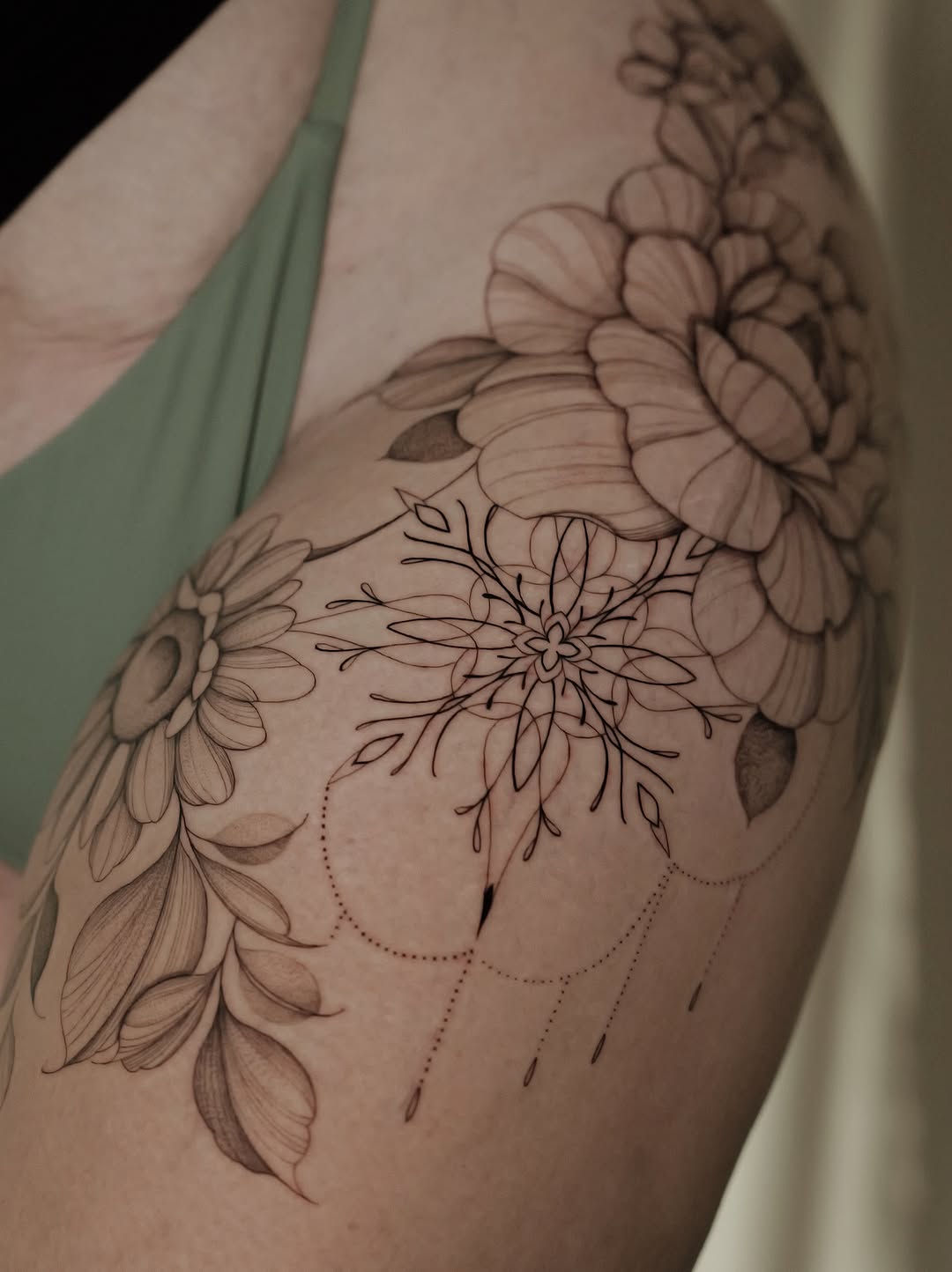 Delicate floral sleeve with fine-line petals and dotwork accents