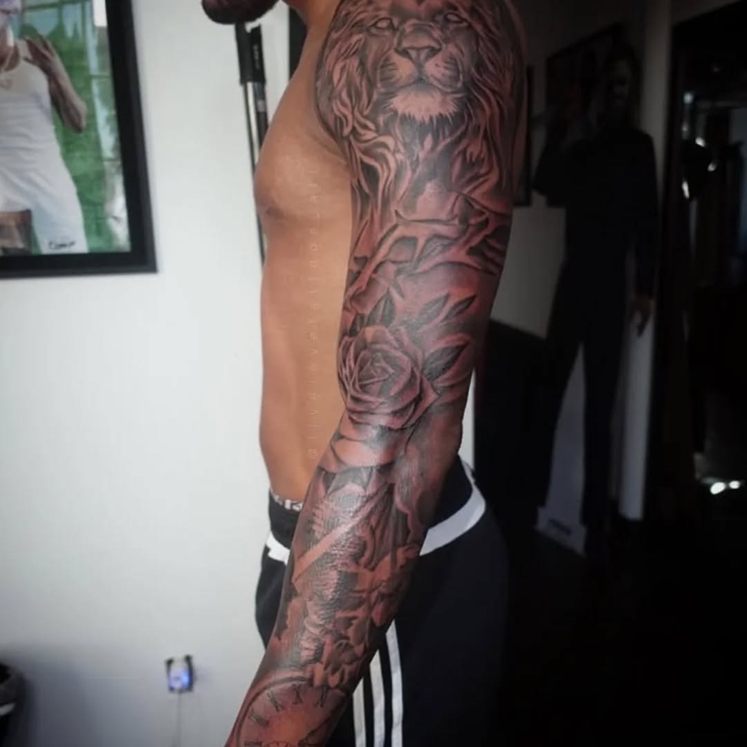 Dramatic black-and-gray full sleeve with roses and a lion