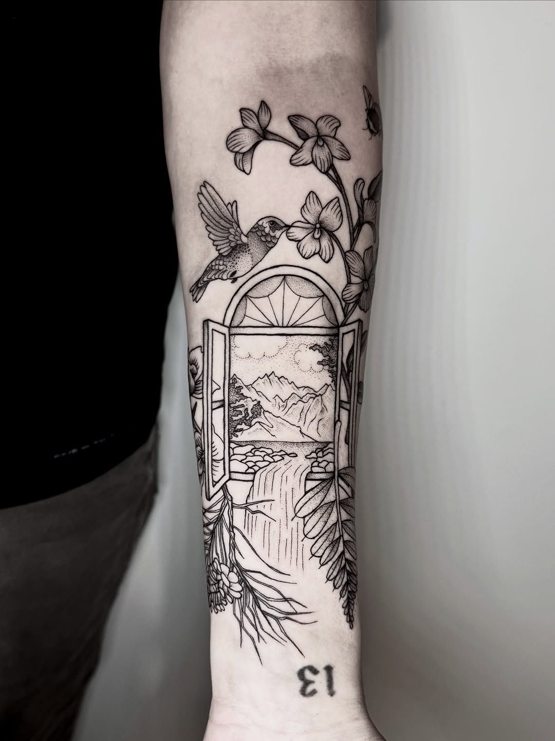 Window-frame landscape, mountains and waterfall; hummingbird among orchids.