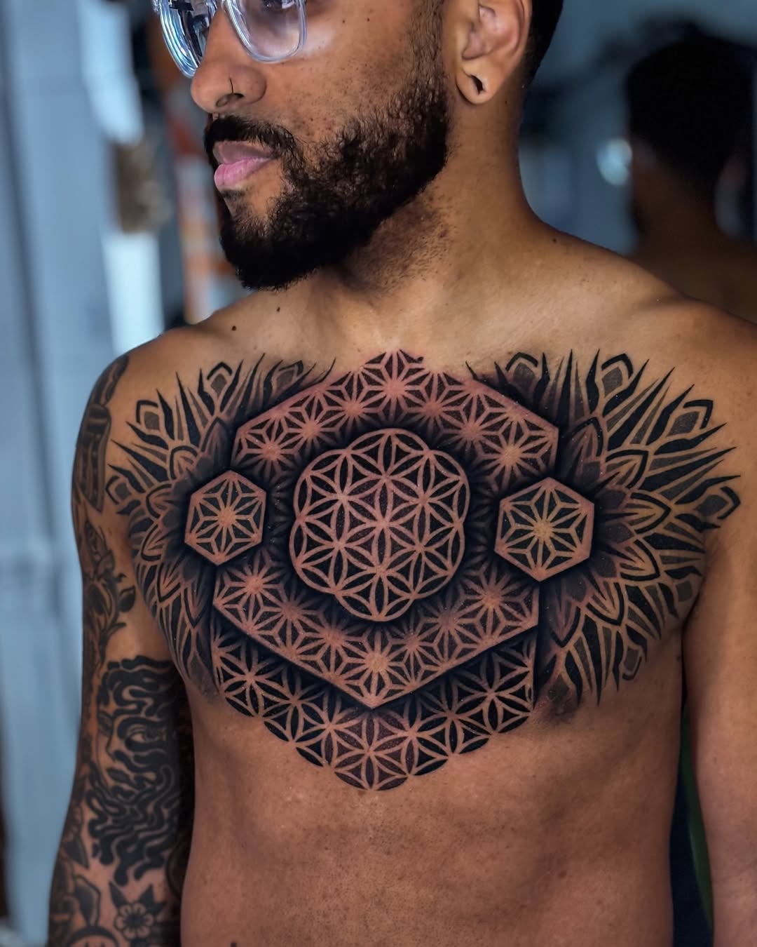 Intricate geometric chest piece with interlocking flower of life pattern