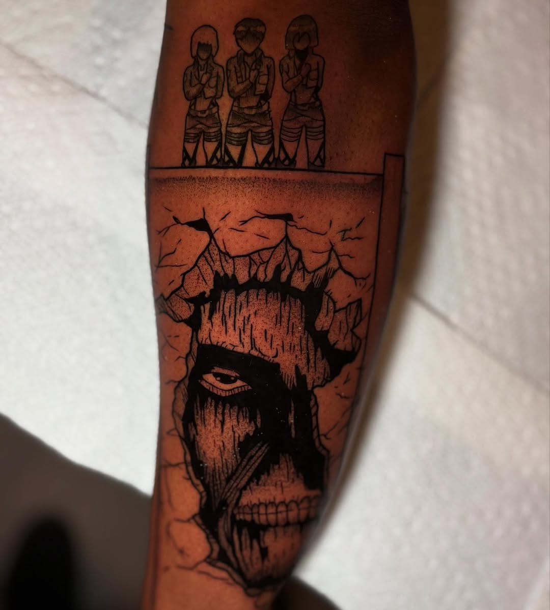 Bold blackwork skull with crack texture and anime figures