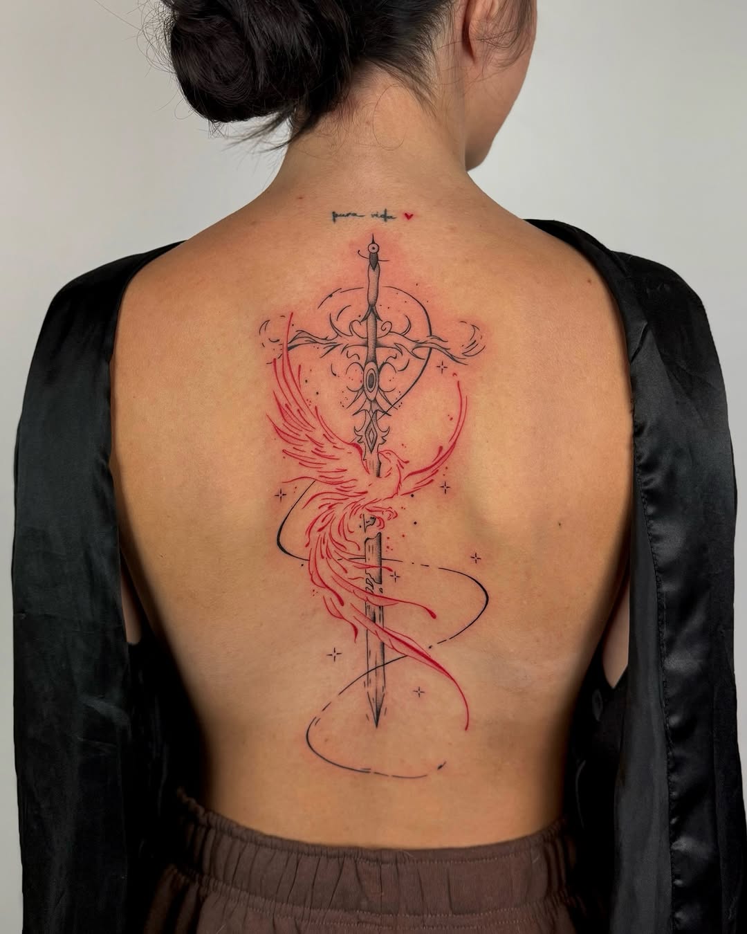 Elegant sword entwined with crimson wings, fine-line details