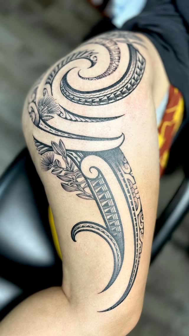 Intricate blackwork tribal spiral with foliate accents