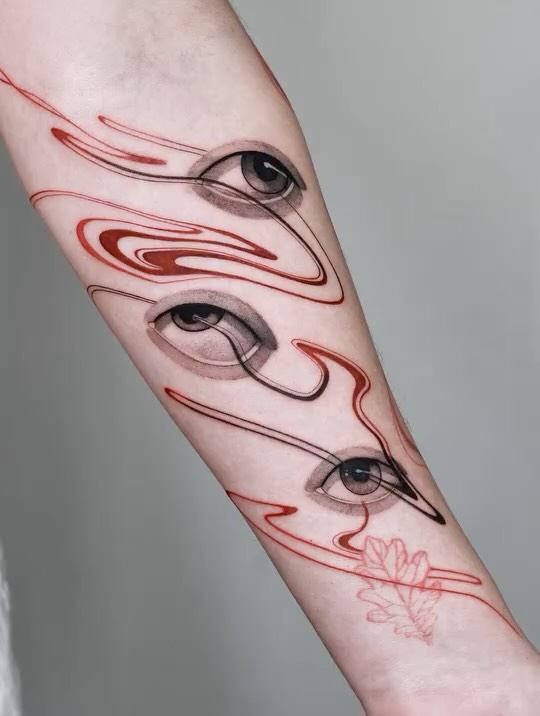 Surreal forearm piece: floating eyes tethered by red ribbons