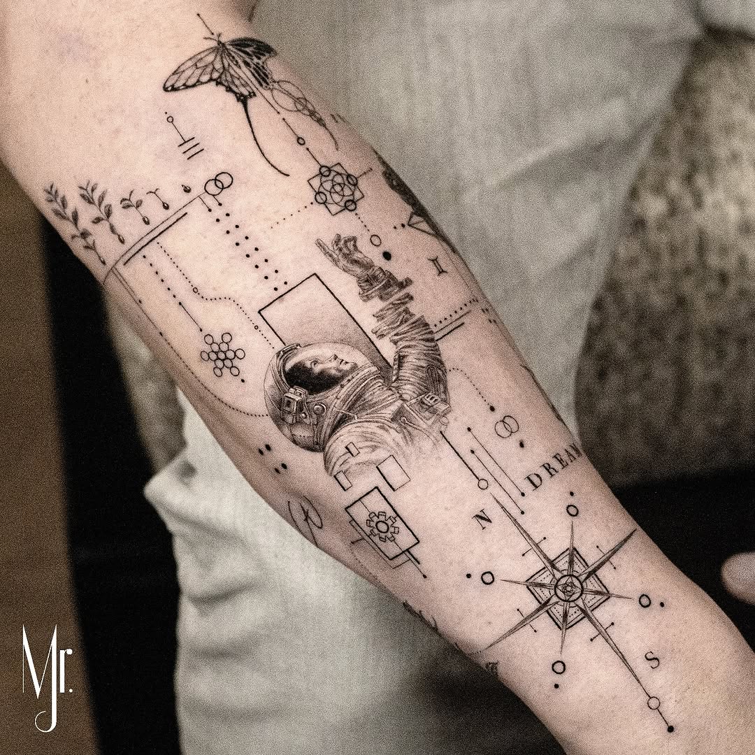 Intricate fineline astronaut with compass geometry on forearm
