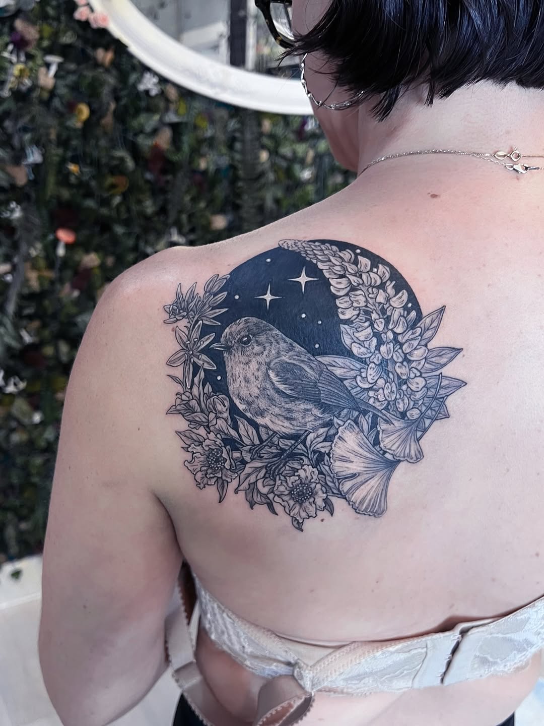 Robin among lupine, camas, pomegranate flowers, and ginkgo.