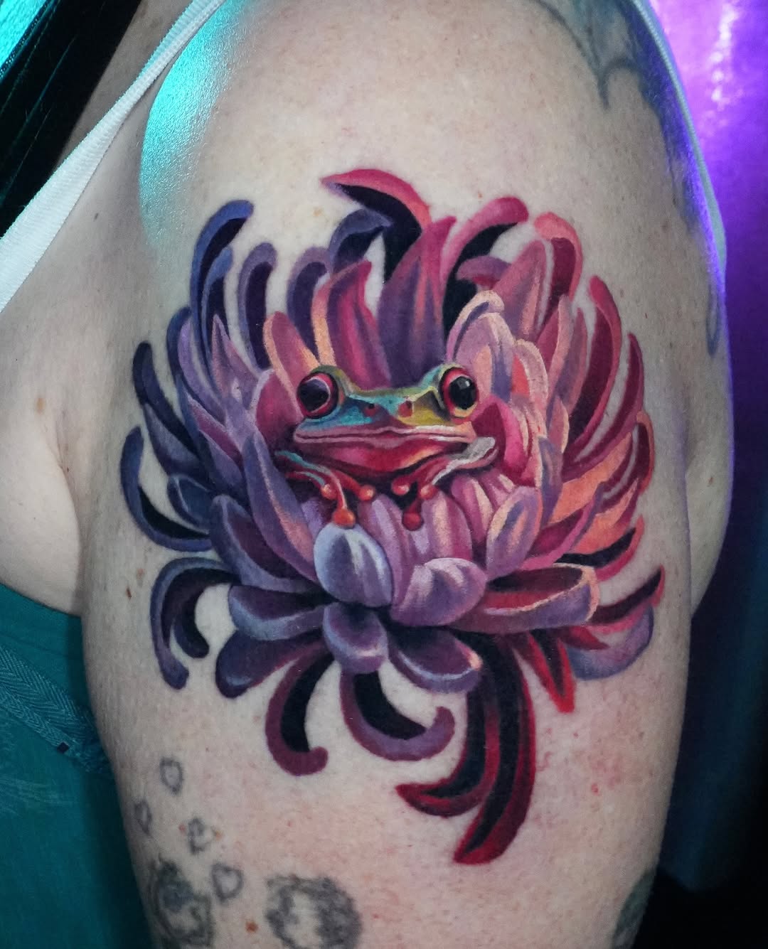 Vibrant, painterly frog nestled in a fiery chrysanthemum