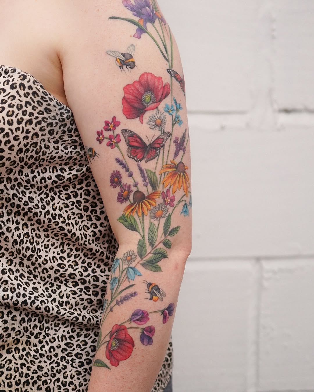 Vibrant watercolor floral sleeve with butterflies and bees.