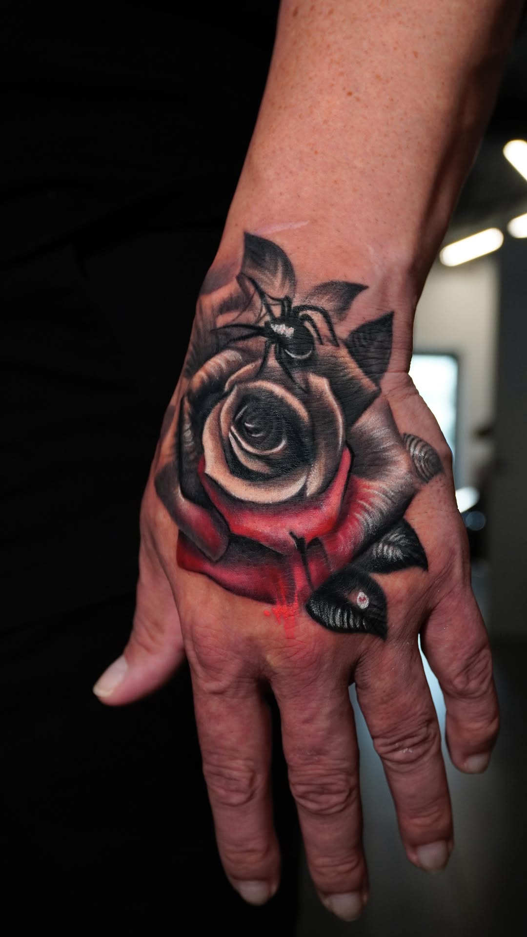 Black and gray hand rose tattoo
