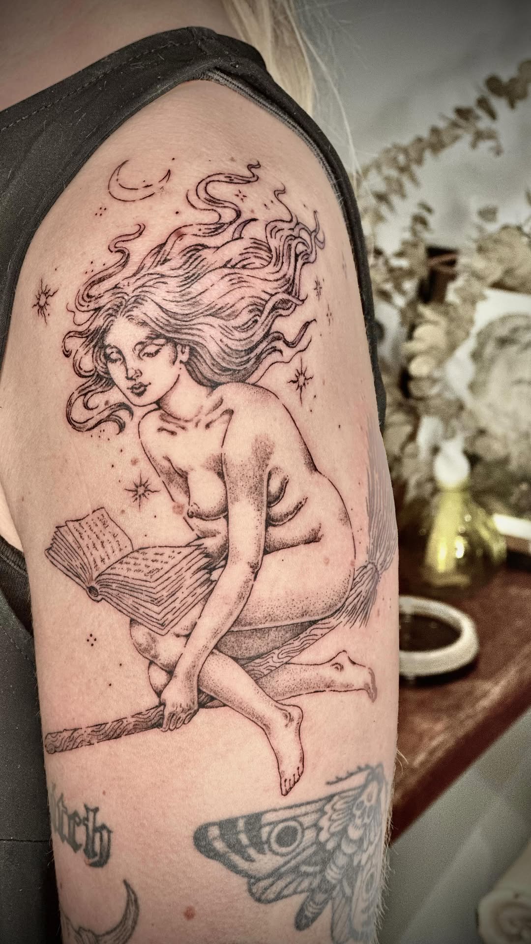 Dreamy nude reader amid flowing hair and stars.