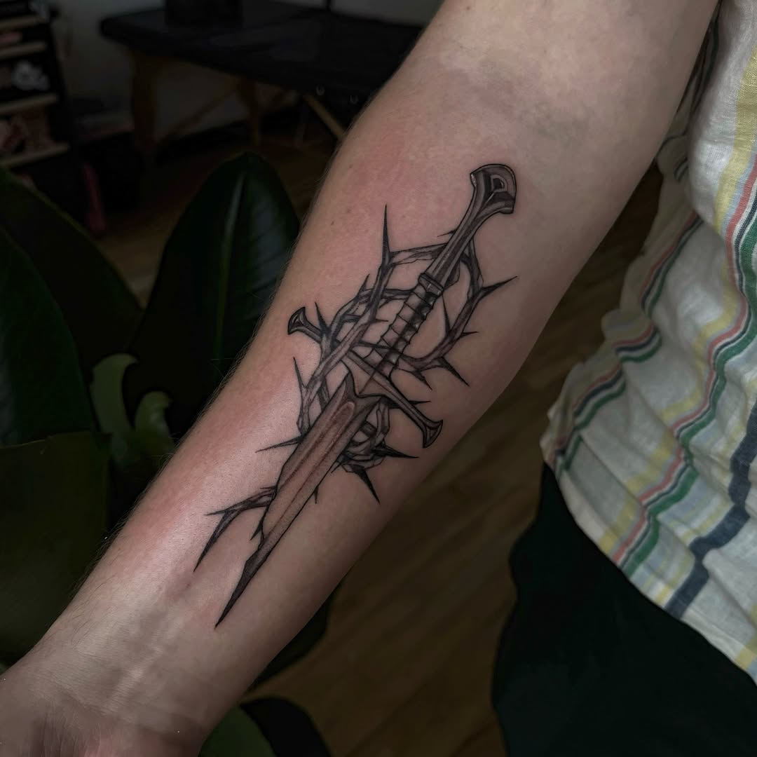 Bold black dagger entwined with thorny vines