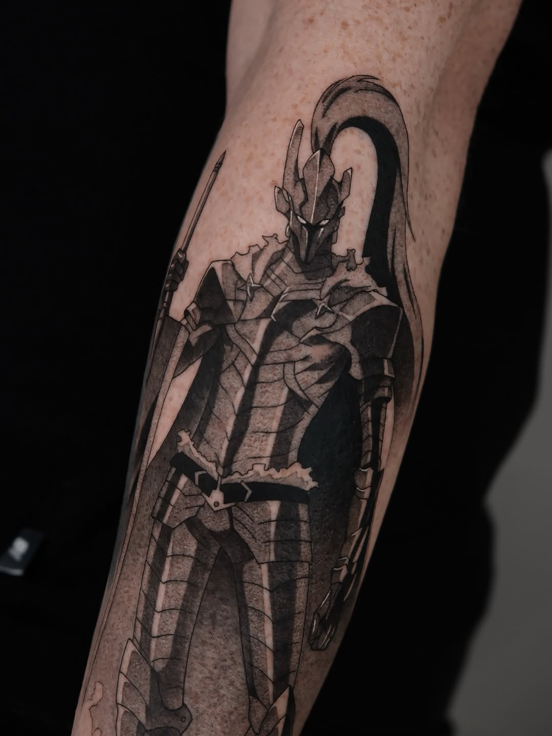 Monolithic blackwork knight in grayscale on forearm