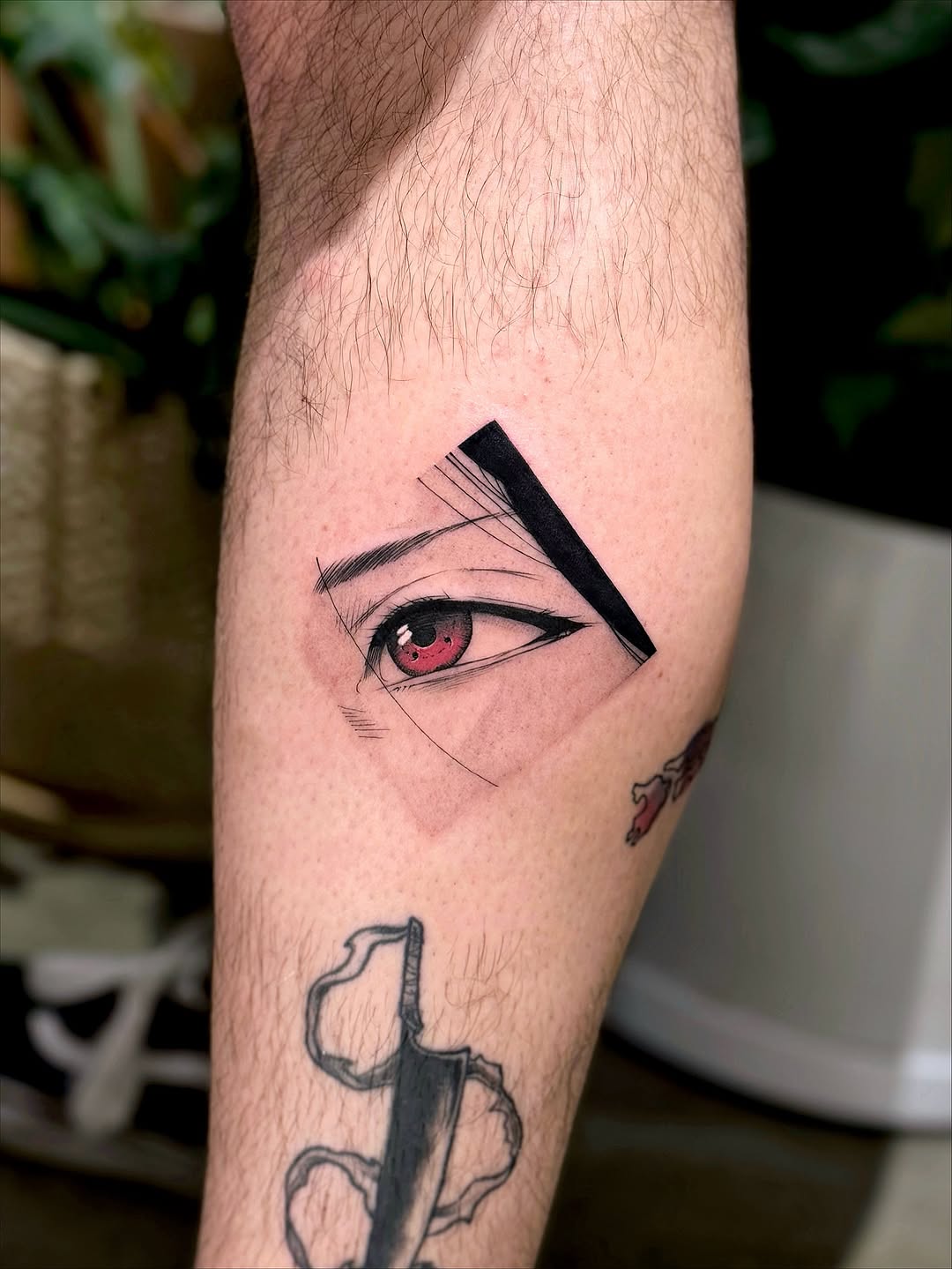 Anime-inspired eye with red iris and bold geometric bar