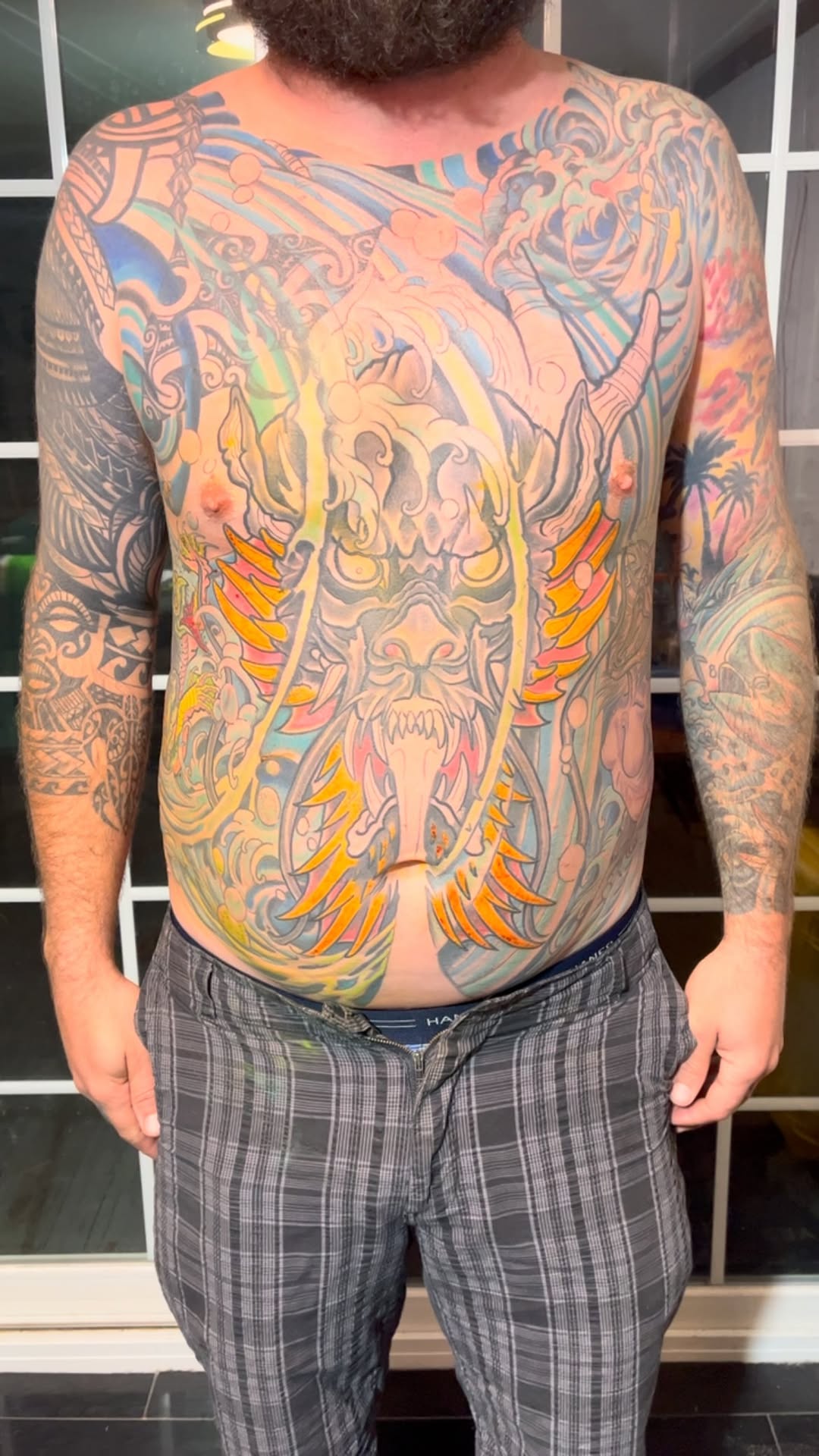 Massive neon dragon-torso with flaming accents and wings