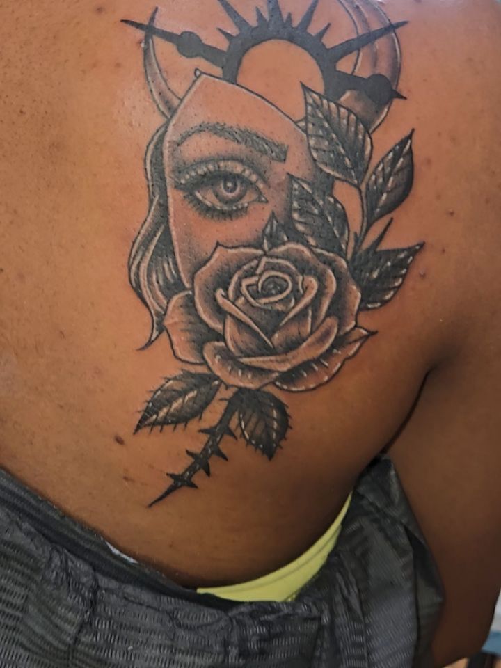 Stark grayscale femme-face entwined with rose and thorns.