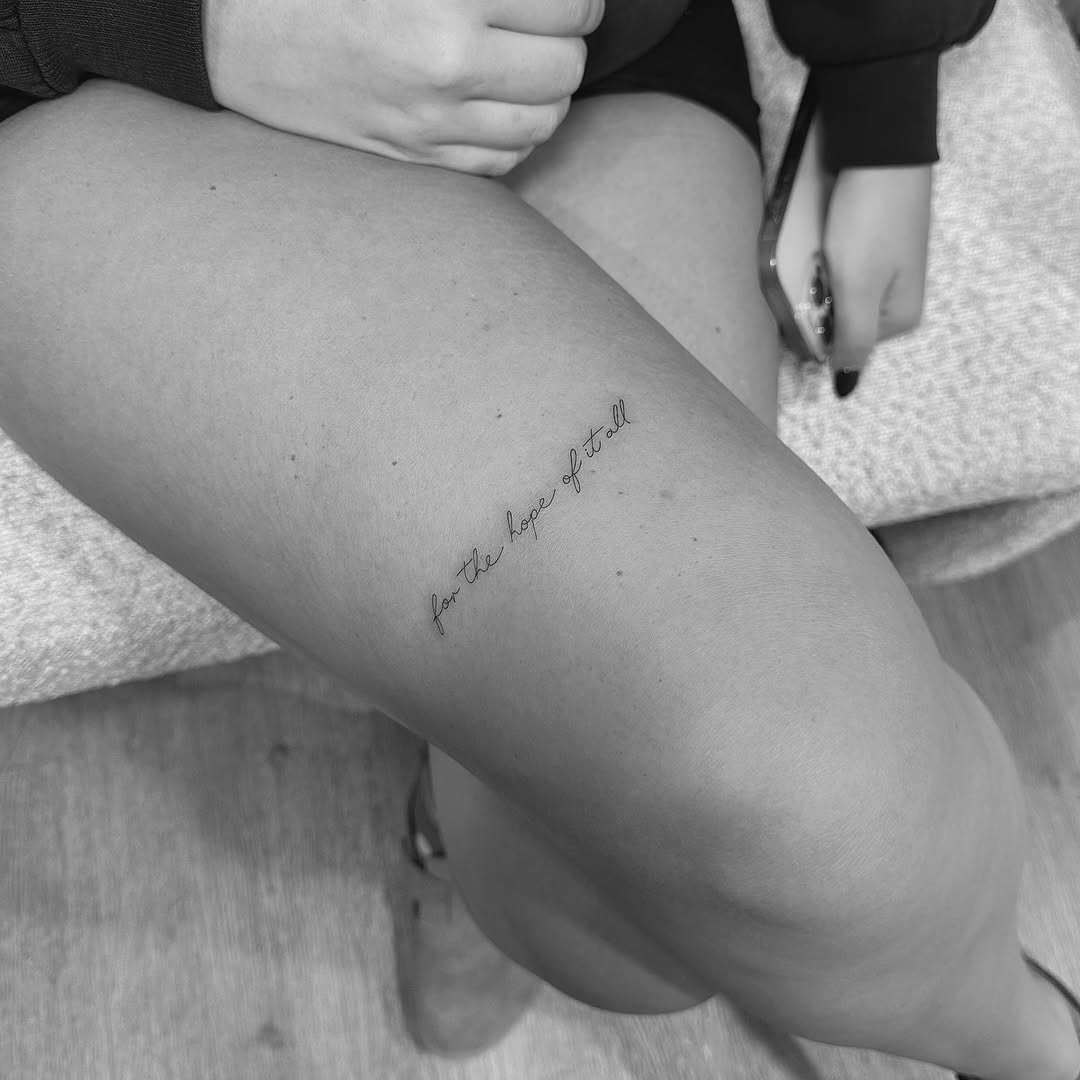 Whispered cursive quote along outer thigh.
