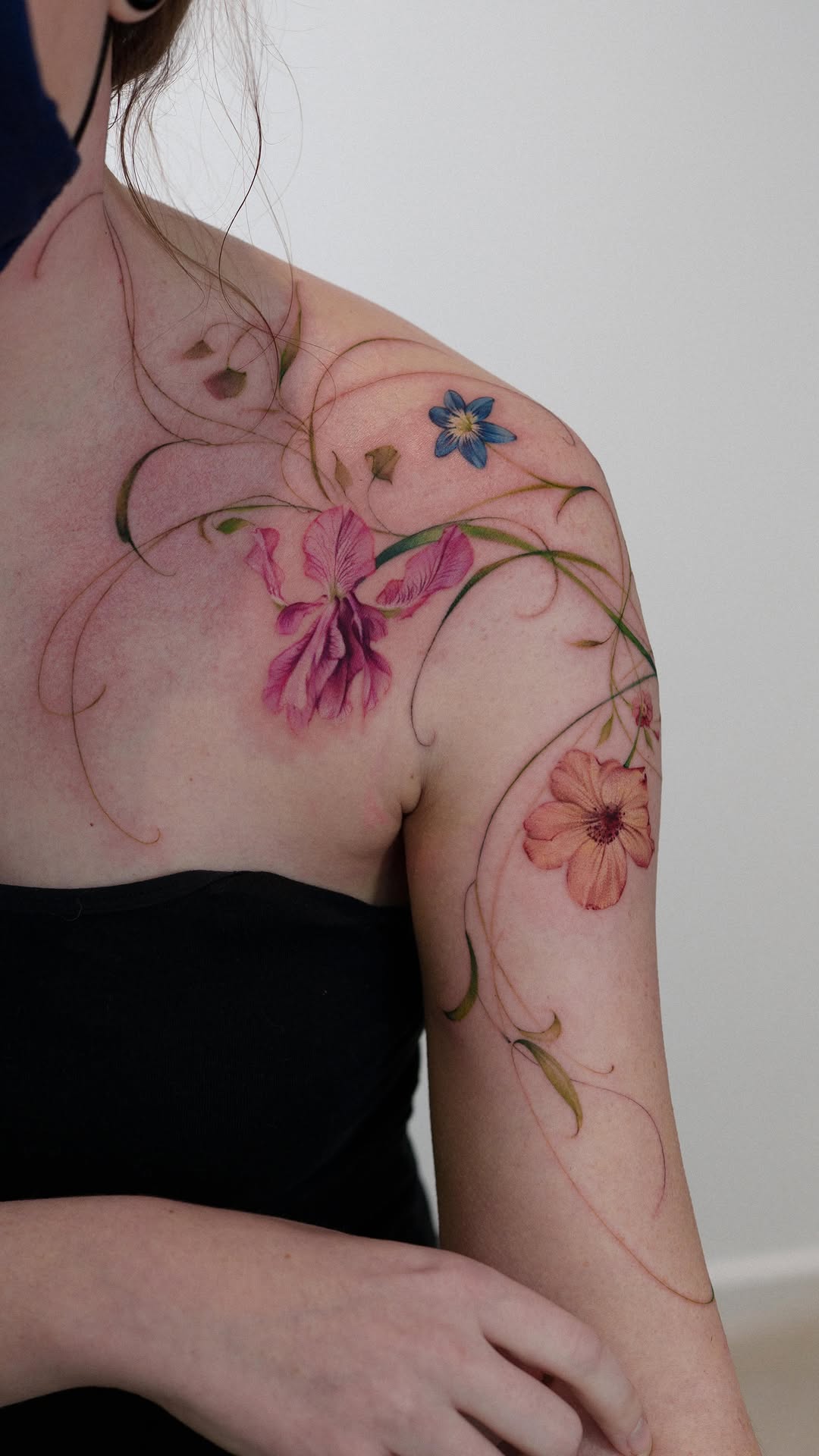Watercolor florals weave across shoulder, with delicate swirling vines.