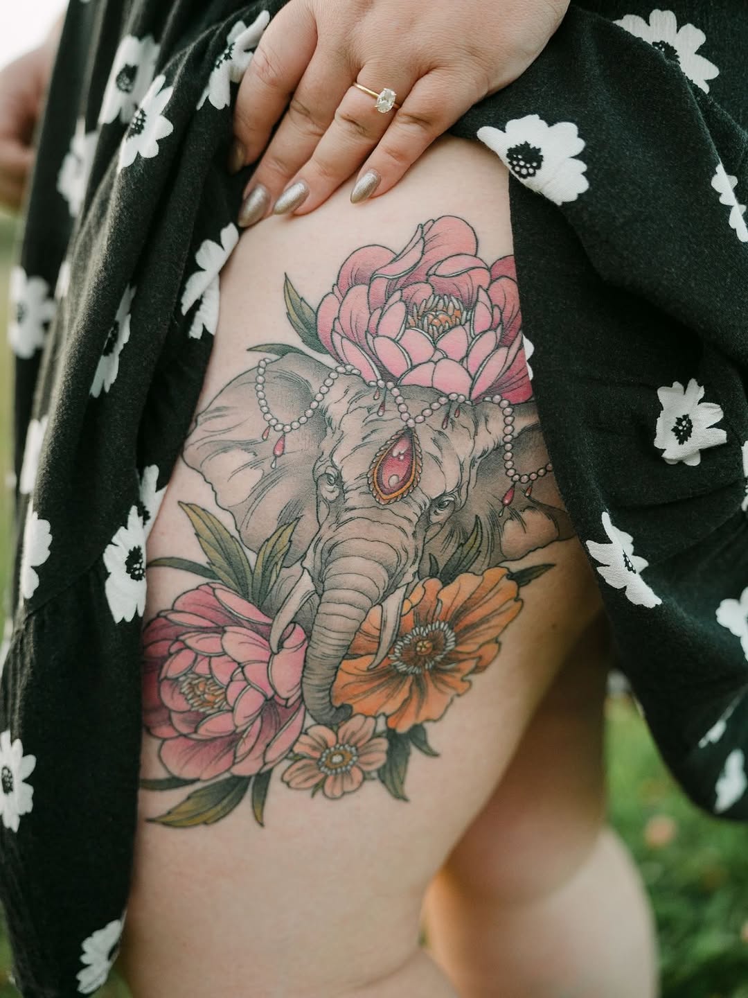 Vivid elephant centerpiece entwined with pink and orange blooms.