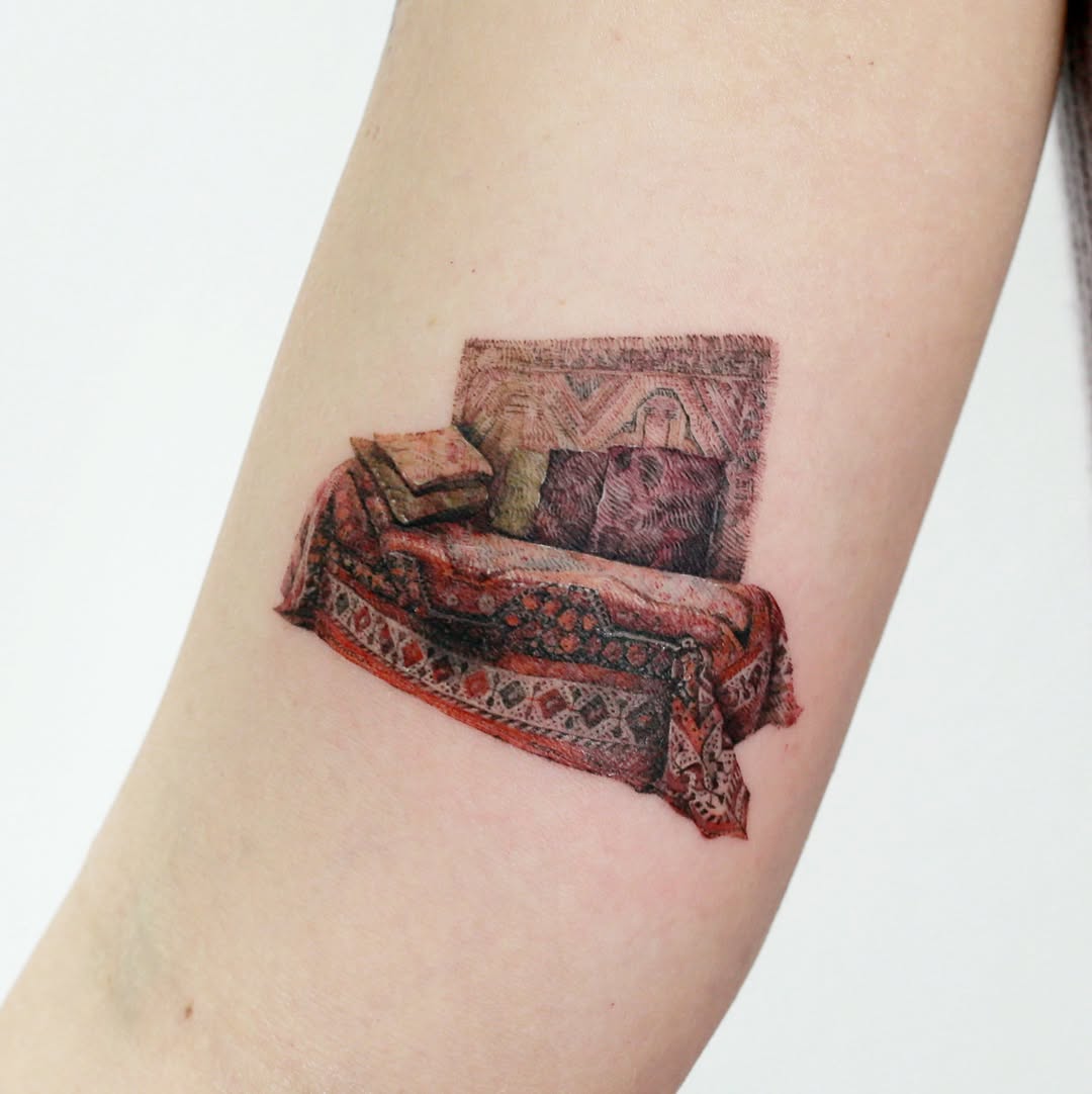 Freud-inspired couch emerging from a richly patterned rug