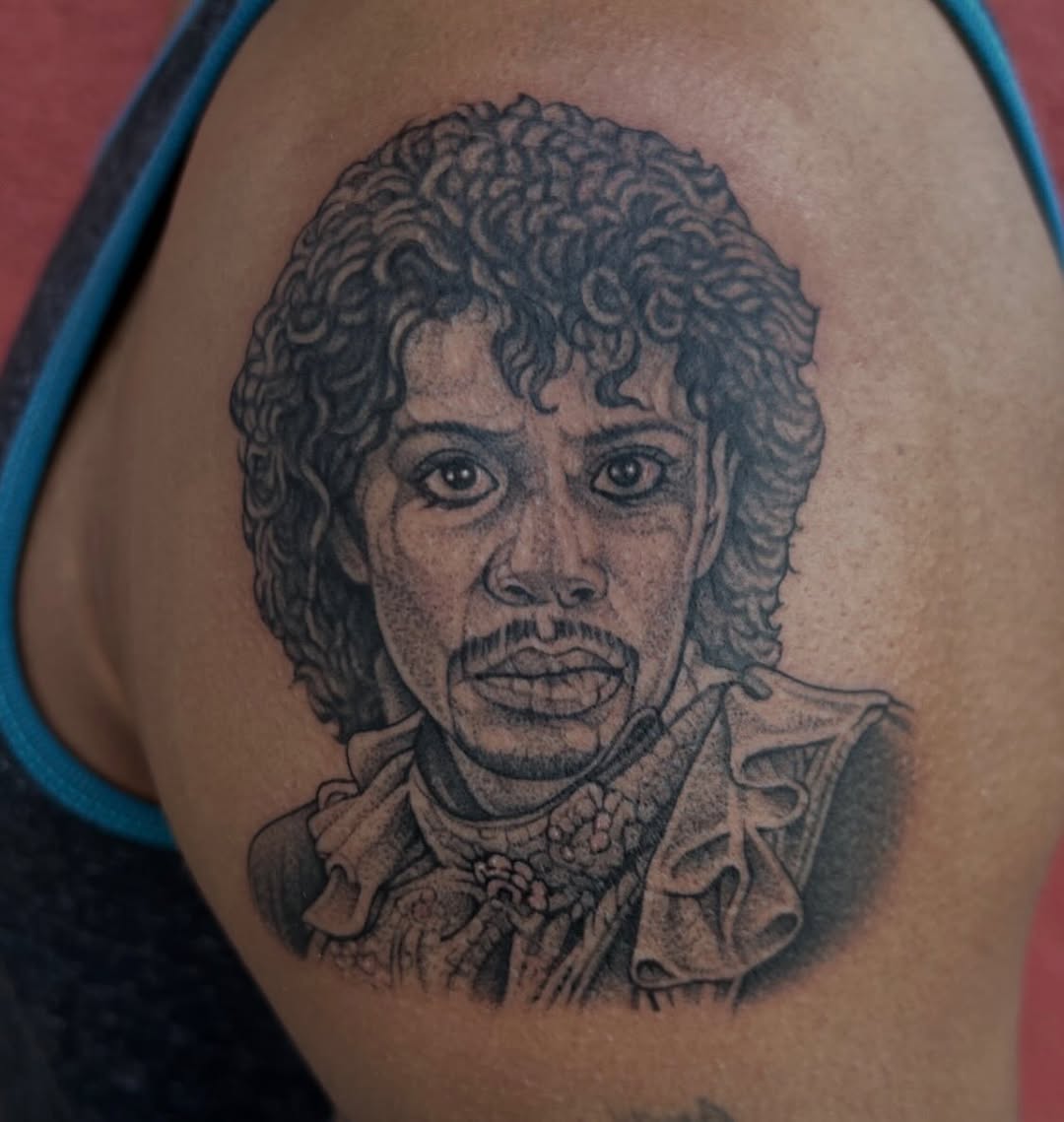 Bold blackwork portrait of a man with curly hair