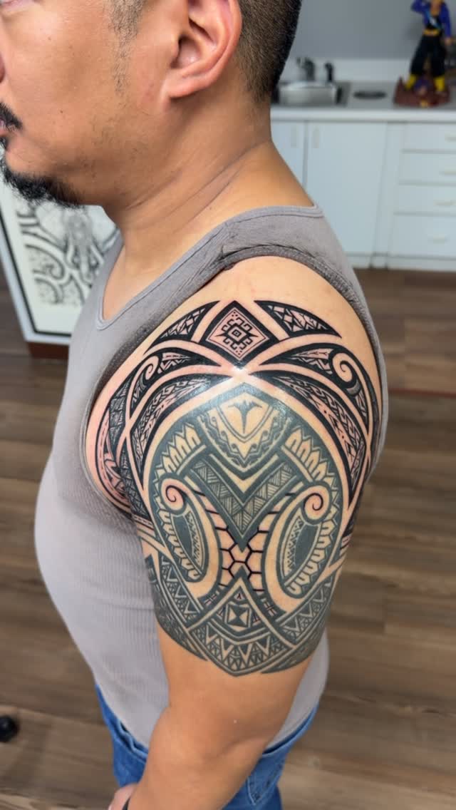 Intricate Polynesian blackwork sleeve with bold geometric motifs