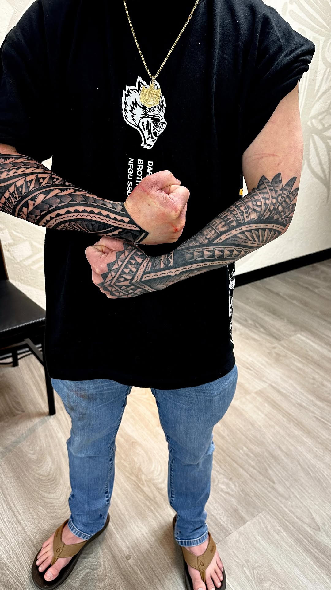 Intricate Polynesian blackwork forearm sleeves, bold geometric patterns