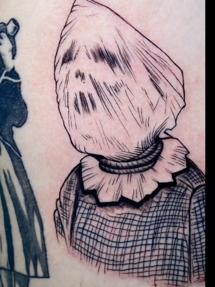 Line-heavy bag-head figure wearing checkered shirt.