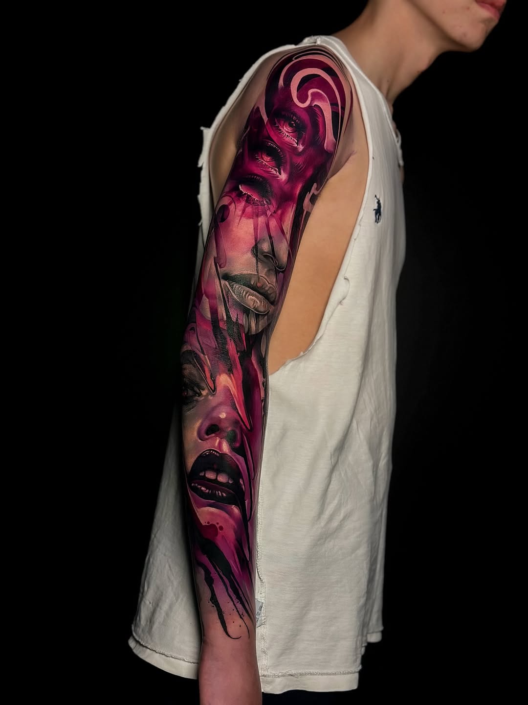 Vivid magenta surreal sleeve featuring stacked faces and swirls.