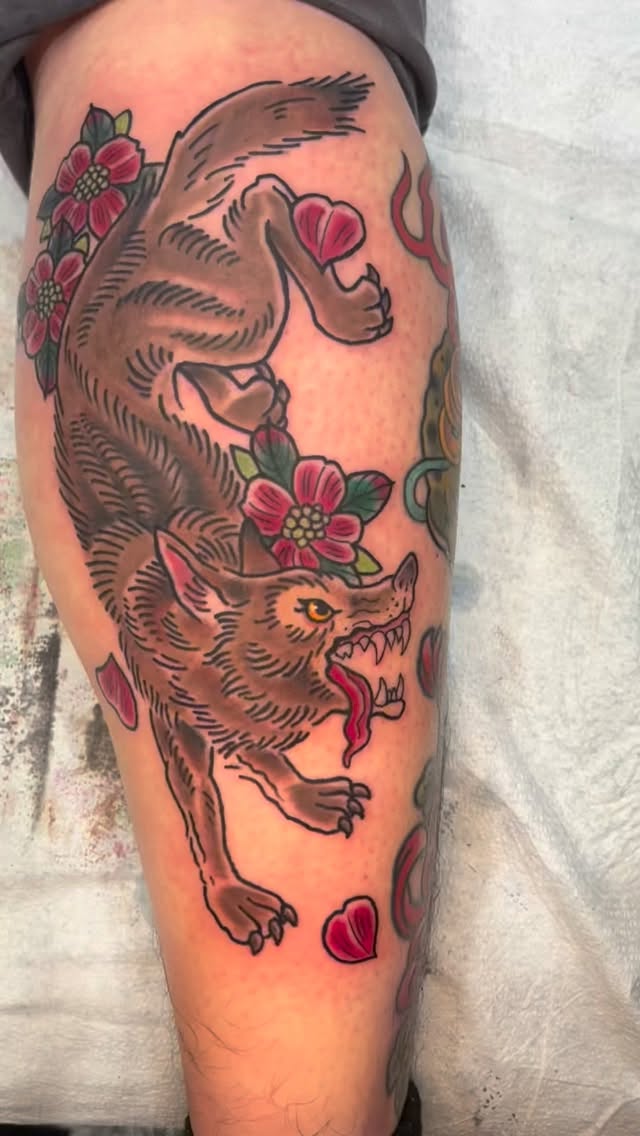 Bold neo-traditional wolf with vibrant floral accents