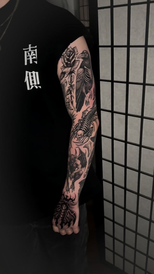 Intricate blackwork sleeve with skeletal fauna and florals