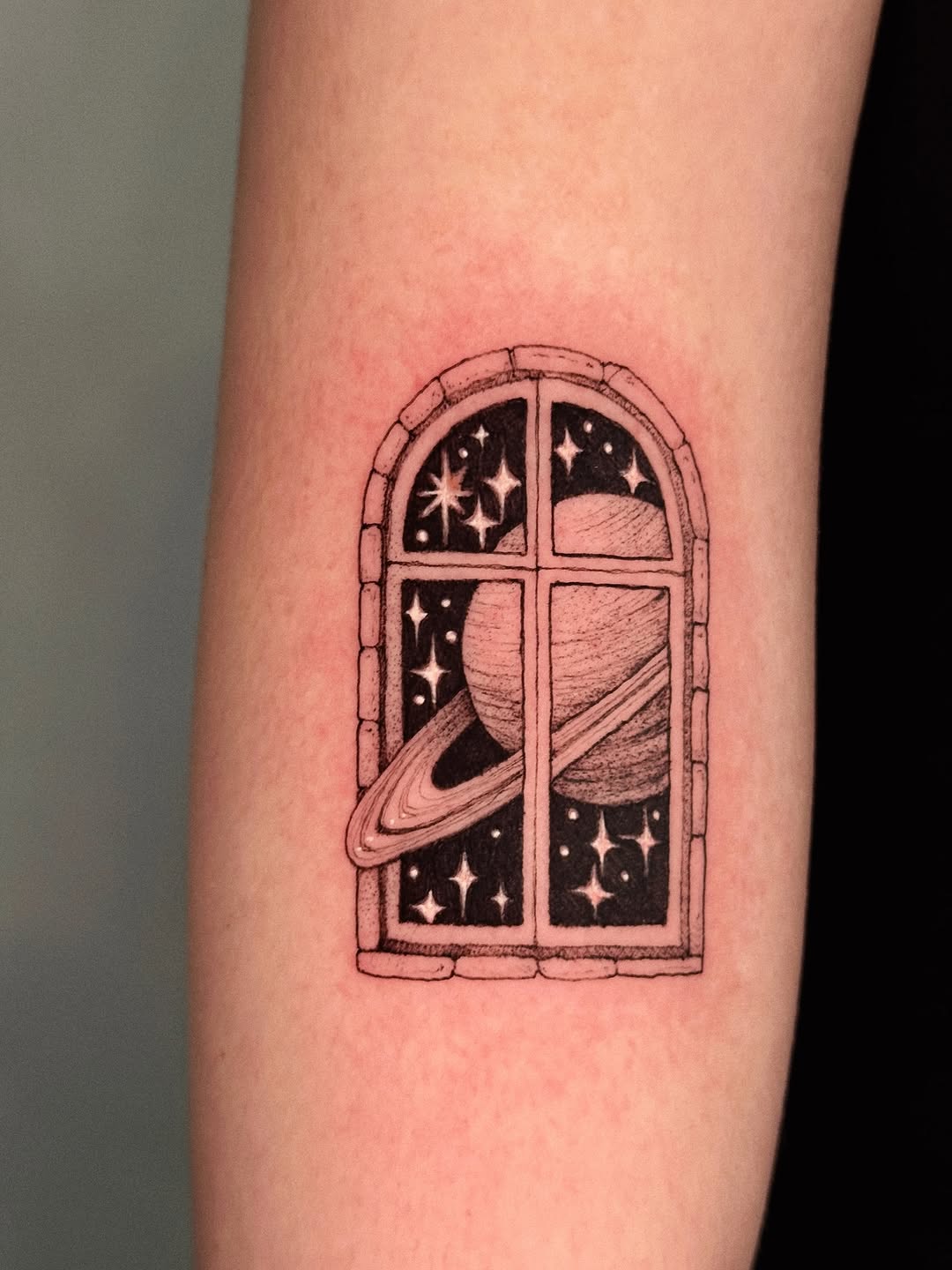 Arched window frame with cosmic scene, Saturn and stars