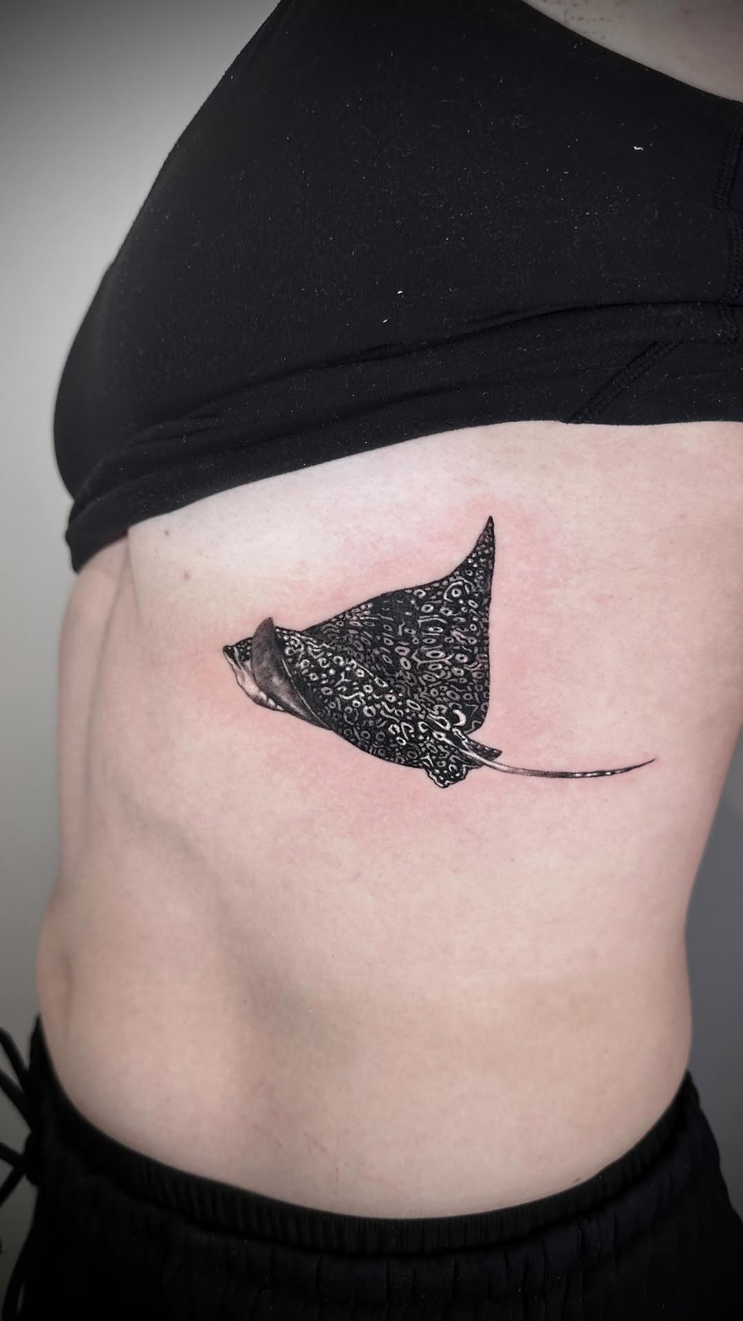 Intricate dotwork manta ray with spotted pattern, flowing tail