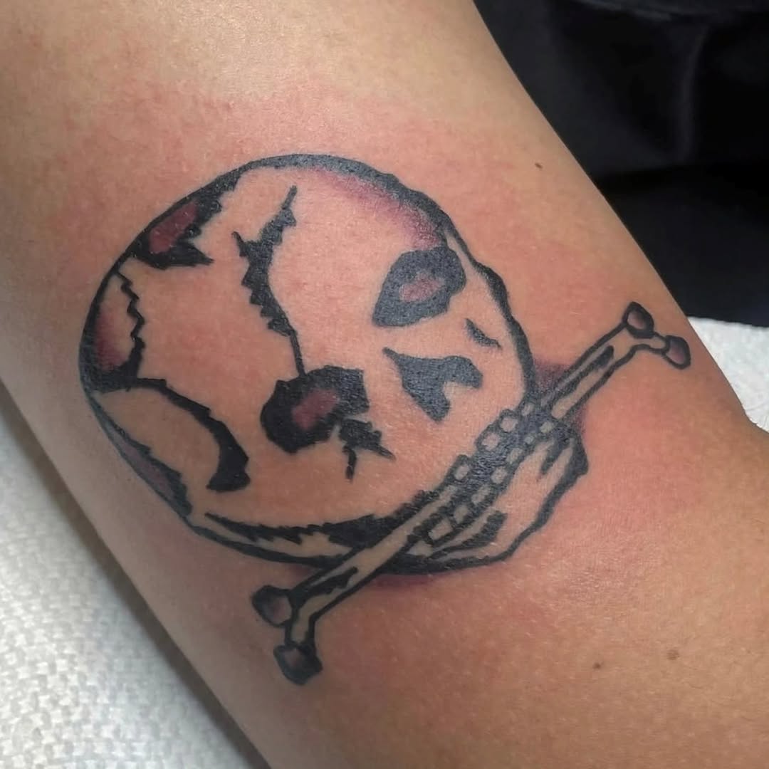 Bold linework globe with crossed bone motif.