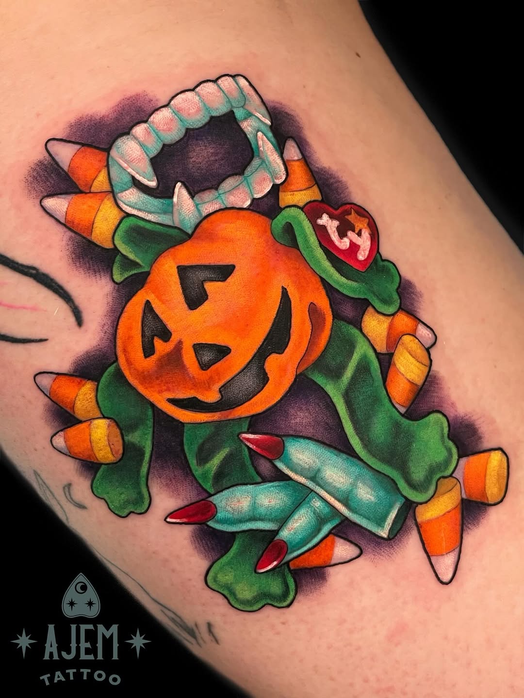 Vibrant jack-o'-lantern centerpiece with teal accents and candy