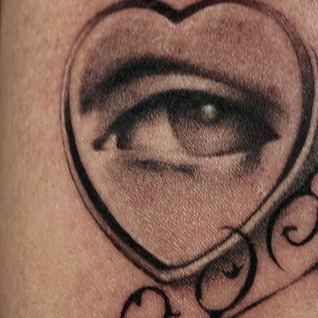 Bold heart-shaped outline encasing a shaded lifelike eye.