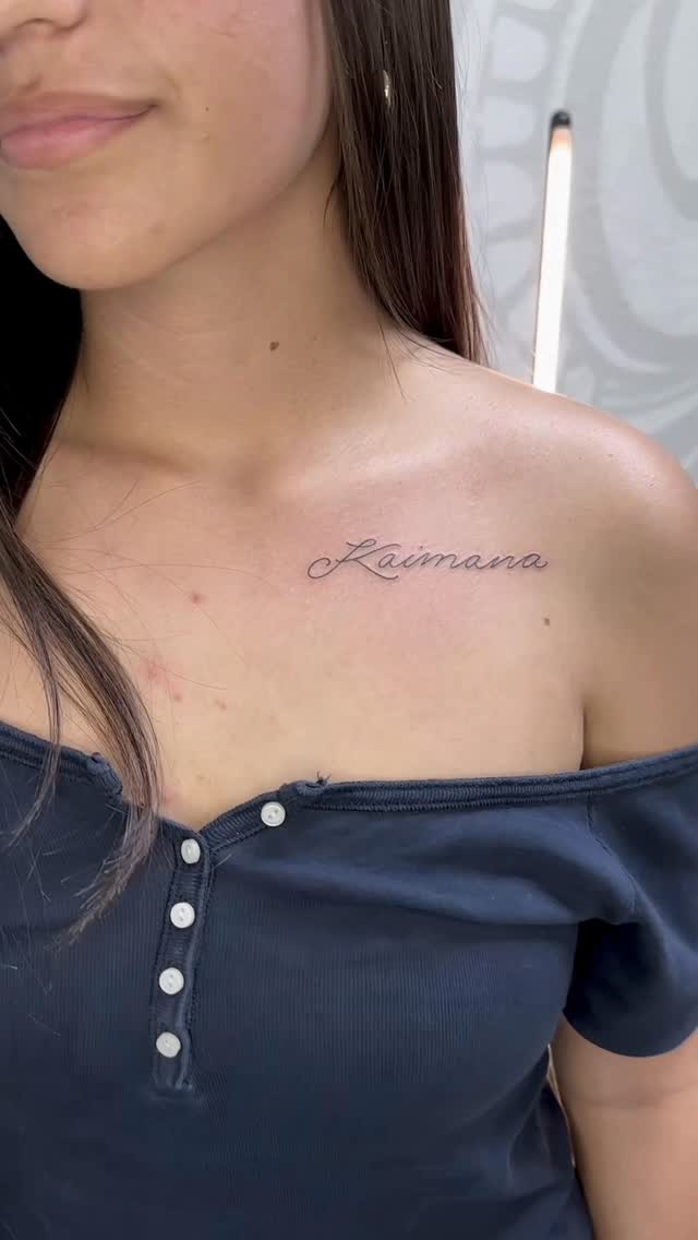 Elegant script memorial name across collarbone
