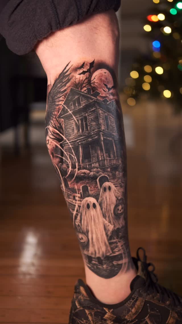 Moody black-and-gray horror leg sleeve with haunted house and ghosts.