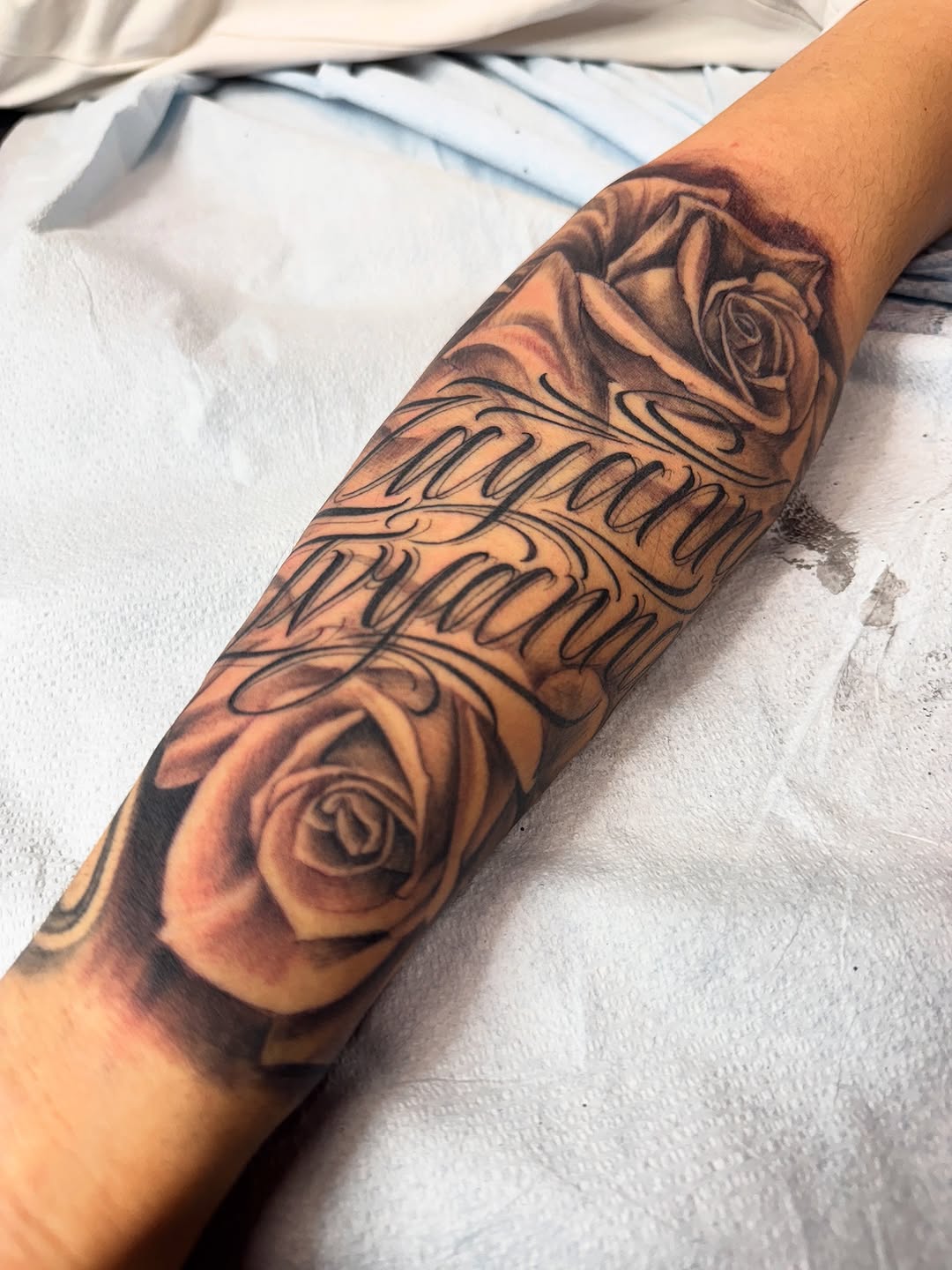 Elegant black-and-gray roses with flowing script lettering