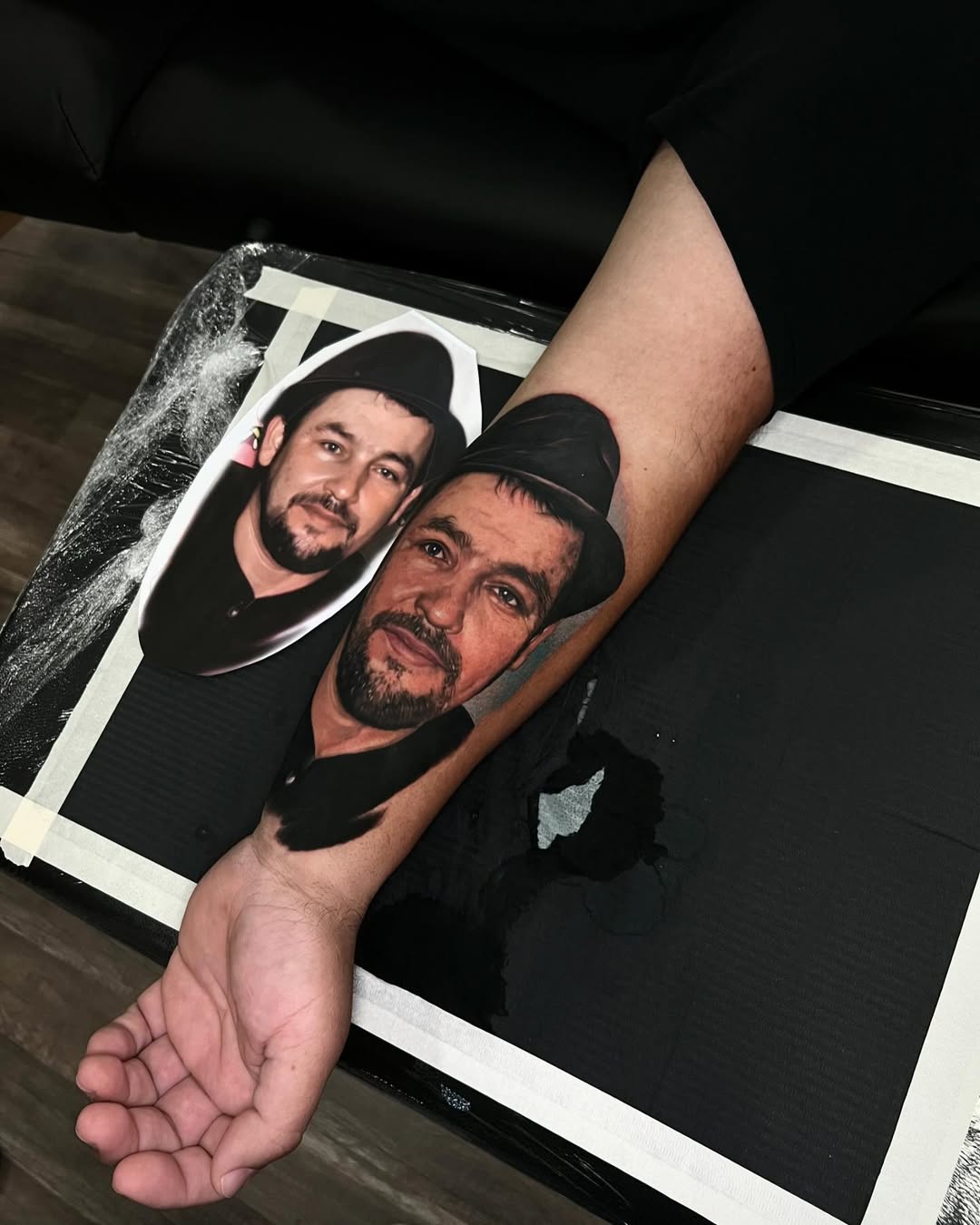 Hyper-realistic dual-portrait forearm tattoo with color tones