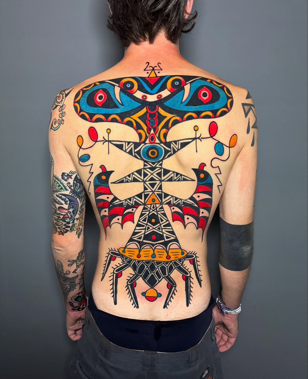 Vibrant geometric back-piece with bold colors and symmetry.