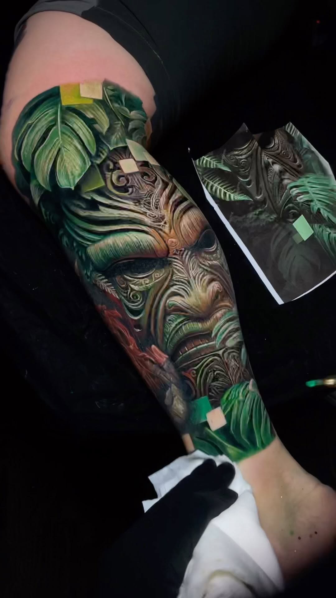 Vibrant tropical foliage sleeve with swirling ornate patterns