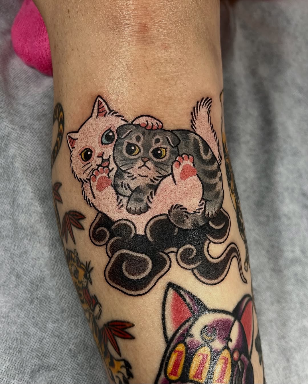 Playful chibi cats perched on swirling black waves