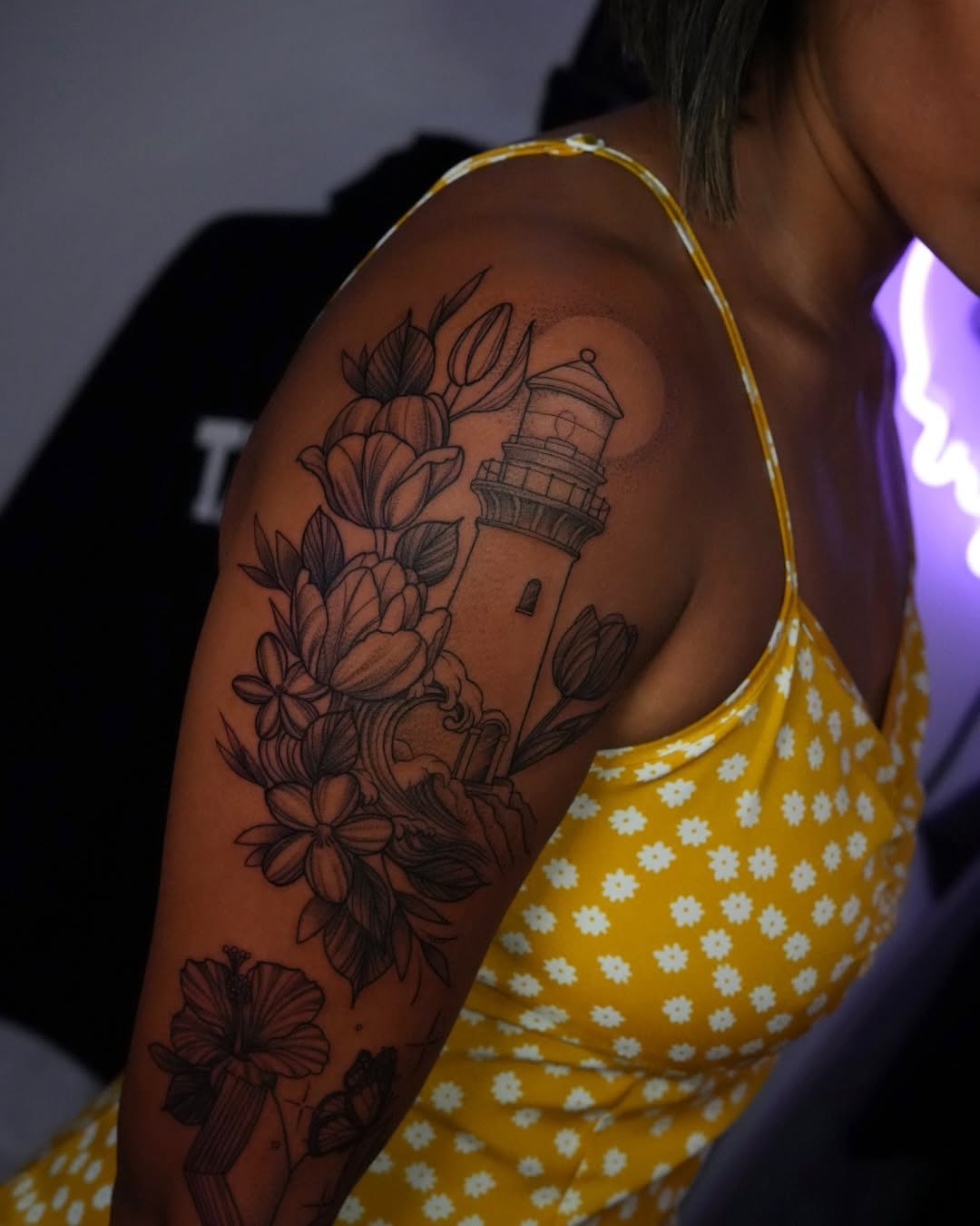 Intricate linework lighthouse surrounded by blooming floral foliage