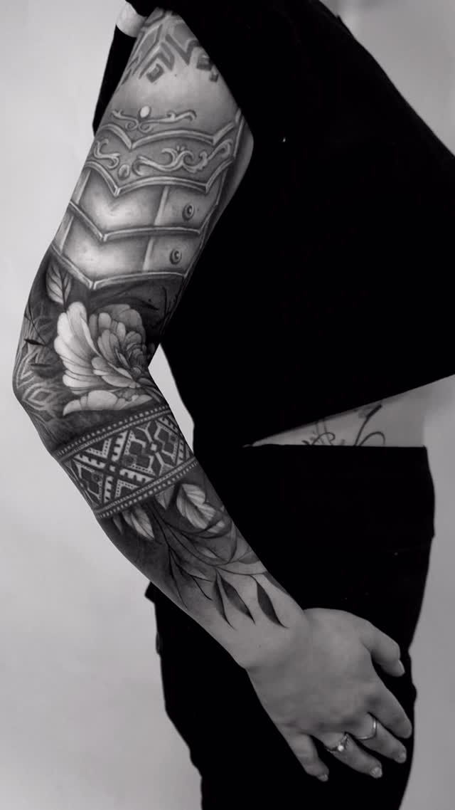 Bold grayscale forearm sleeve with lush floral and ornamental geometric patterns.
