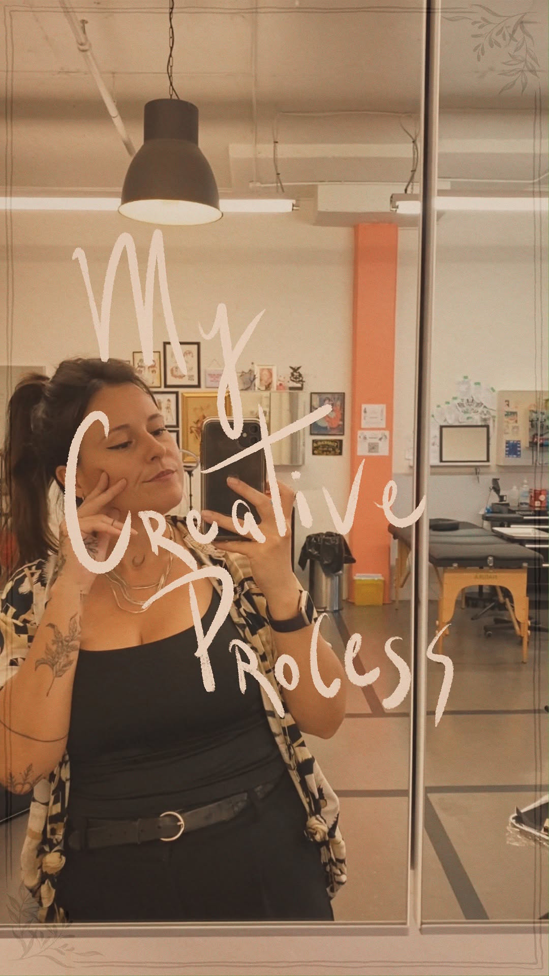 Delicate blackline floral forearm tattoo, softly lit studio